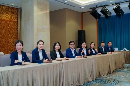 Hình ảnh doanh nghiệp cuốn hút với hàng ghế lãnh đạo ngồi nghiêm túc sau bàn hội nghị dài, vest xanh chỉn chu kết hợp không gian sang trọng tạo cảm giác uy tín rõ nét