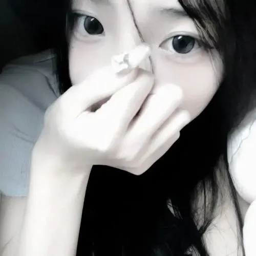 Gái đẹp ngồi ghế sofa da cầm sách che miệng, tóc dài layer nâu, áo len turtleneck ôm sát.