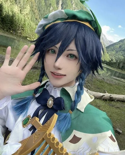 Nữ cosplayer mỉm cười nhìn thẳng ống kính, mũ xanh nhỏ và tóc ngắn rối nhẹ làm tạo hình Venti thêm tự nhiên